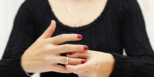 Woman removing a wedding ring, illustrating separation and khula
